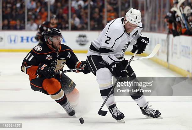 Matt Greene of the Los Angeles Kings is pursued by Saku Koivu of the Anaheim Ducks for the puck in the first period of Game Five of the Second Round...