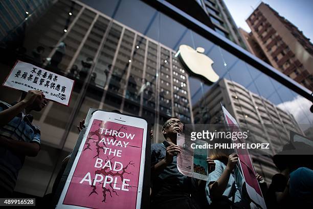 Rights campaigners stage a protest coinciding with the launch of the new iPhone 6s outside an Apple store in Hong Kong on September 25, 2015. Apple...