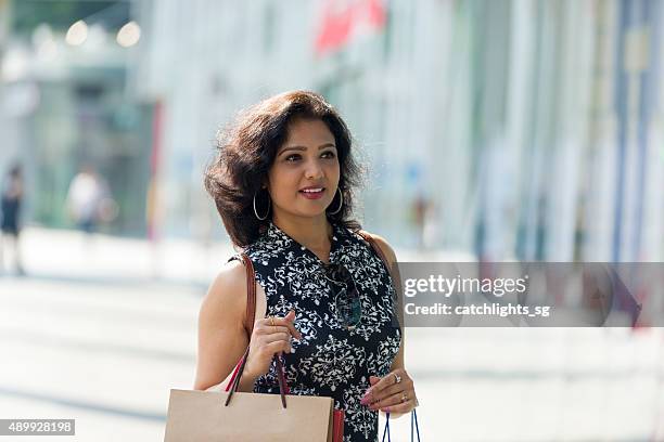 asian indian woman shopping at shopping district - sleeveless shirt stock pictures, royalty-free photos & images