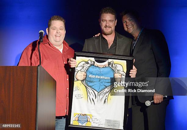 Comedian Ralphie May, Honoree Rob Beckham of WME, and Storme Warren speak onstage during the T.J. Martell Ambassador Of The Year Awards at The...