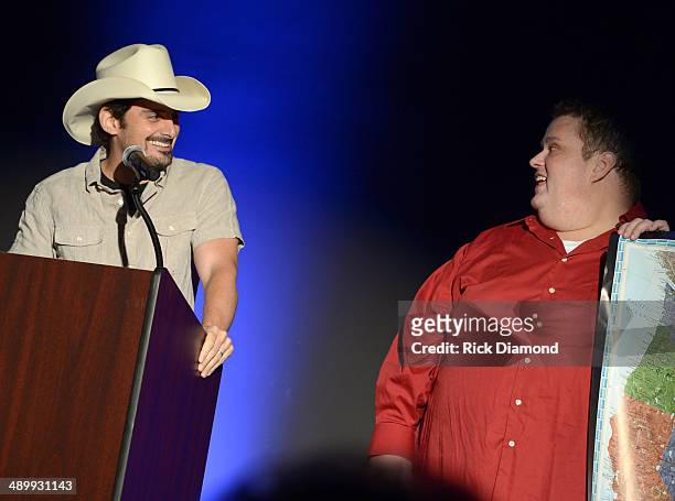 Singer-songwriter Brad Paisley and comedian Ralphie May speak onstage during the T.J. Martell Ambassador Of The Year Awards at The Rosewall on May...