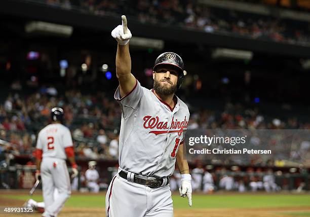 Kevin Frandsen of the Washington Nationals points to the fans after hitting a solo home run against the Arizona Diamondbacks during the ninth inning...