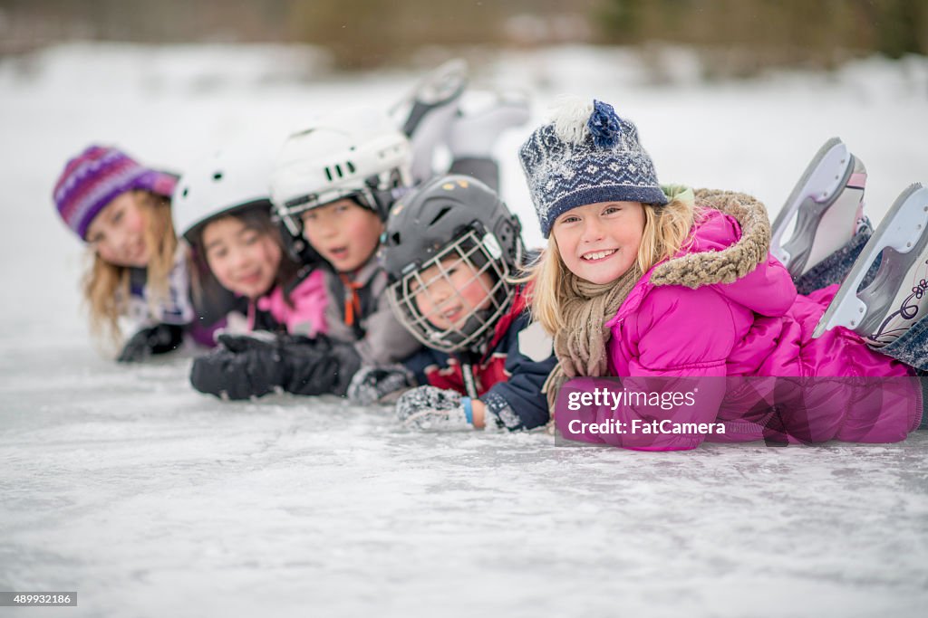 Children in a Row Playing on the Ice