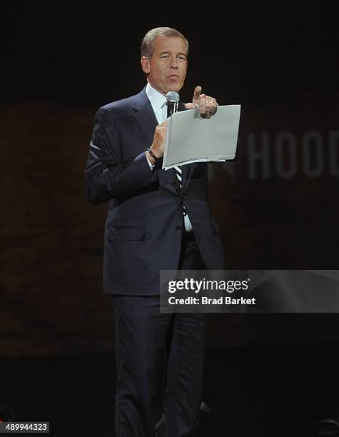 Anchor and managing editor of NBC Nightly News Brian Williams peaks at The Robin Hood Foundation's 2014 Benefit at the Jacob Javitz Center on May 12,...