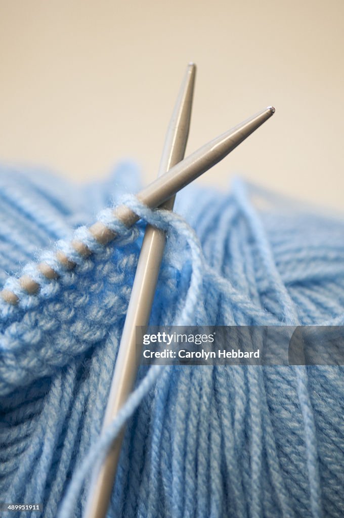 Close up of wool on knitting needles