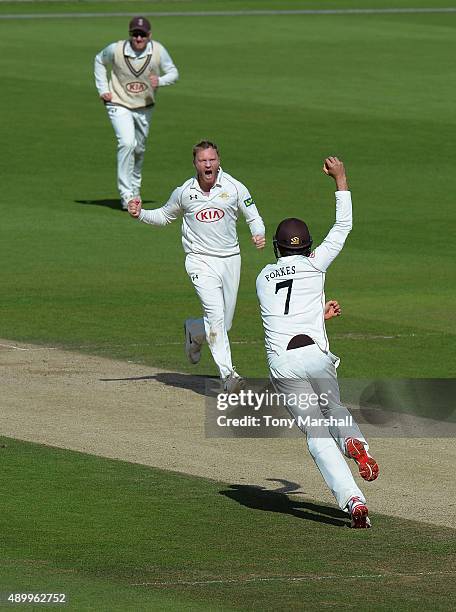 Ben Foakes of Surrey celebrates catching Josh Cobb of Northamptonshire with Gareth Batty of Surrey during the LV County Championship - Division Two...