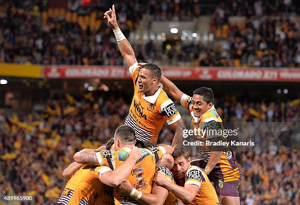 Justin Hodges of the Broncos and team mates celebrate a try by Jack Reed during the NRL First Preliminary Final match between the Brisbane Broncos...