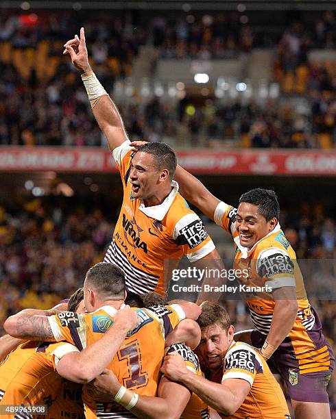 Justin Hodges of the Broncos and team mates celebrate a try by Jack Reed during the NRL First Preliminary Final match between the Brisbane Broncos...