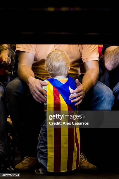 Child wearing a pro-independence flag is seen during a 'Junts pel Si' coalition rally on September 24, 2015 in Girona, Spain. The main Catalanist...