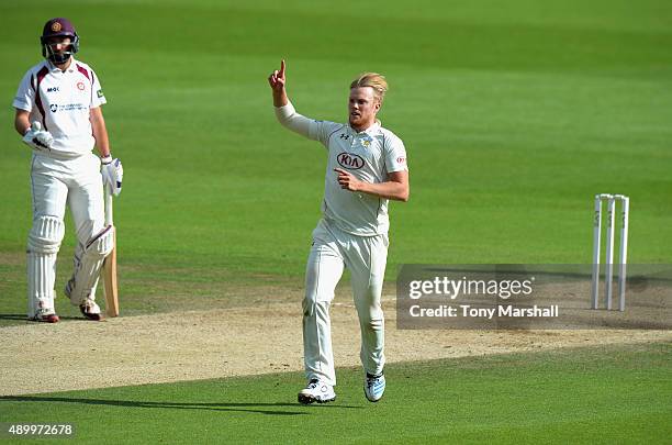 Matt Dunn of Surrey celebrates taking the wicket of Graeme White of Northamptonshire during the LV County Championship - Division Two match between...