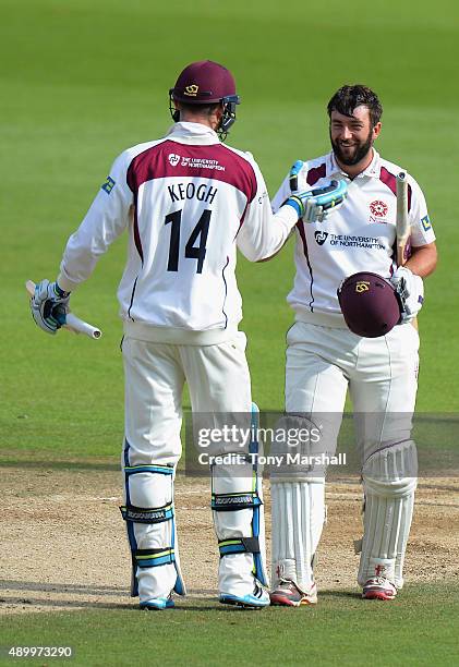 Rob Keogh of Northamptonshire congratulates David Murphy of Northamptonshire on reaching his maiden first class 100 during the LV County Championship...