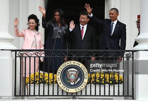 Peng Liyuan, wife of Chinese President Xi Jinping, U.S. First lady Michelle Obama, Chinese President Xi Jinping and U.S. President Barack Obama wave...