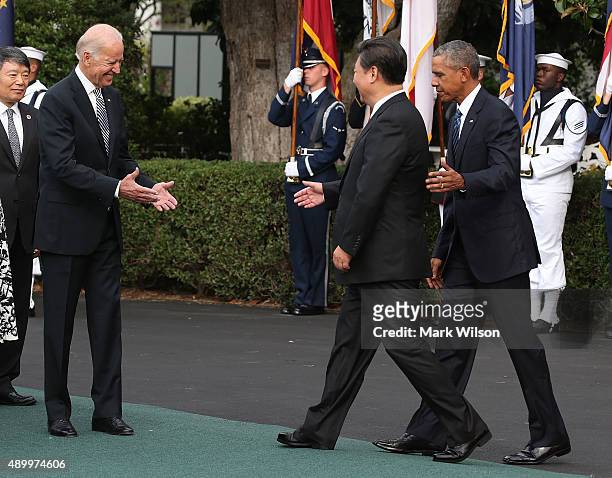 Vice President Joseph Biden reaches to shake hands with Chinese president Xi Jinping , as US President Barack Obama stands nearby during arrival...
