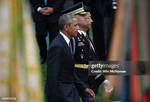 President Barack Obama and Chinese President Xi Jinping review U.S. Troops during a state arrival ceremony on the south lawn of the White House...