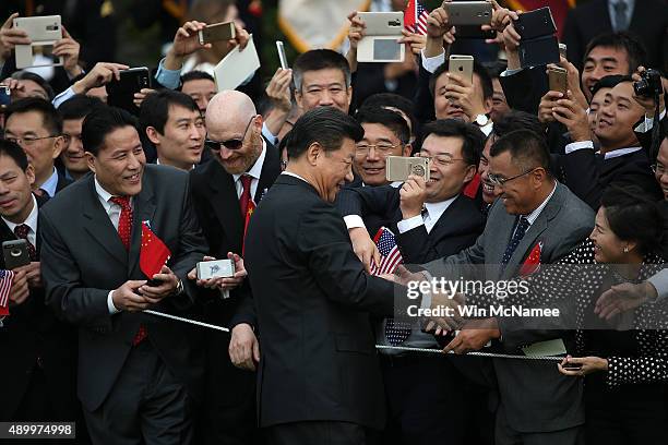 Chinese President Xi Jinping greets guests gathered during a state arrival ceremony on the south lawn of the White House grounds September 25, 2015...