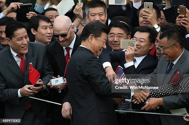 Chinese President Xi Jinping greets guests gathered during a state arrival ceremony on the south lawn of the White House grounds September 25, 2015...