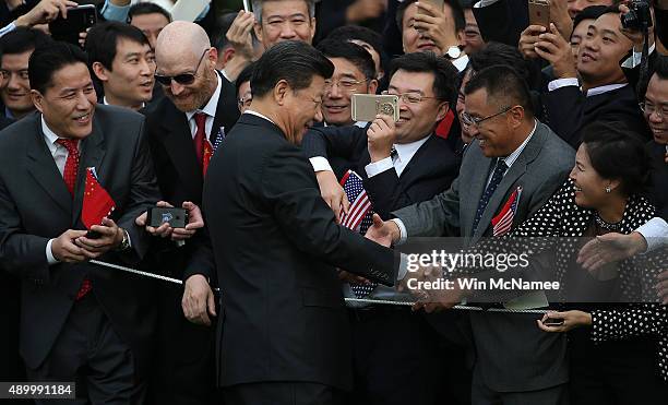 Chinese President Xi Jinping greets guests gathered during a state arrival ceremony on the south lawn of the White House grounds September 25, 2015...