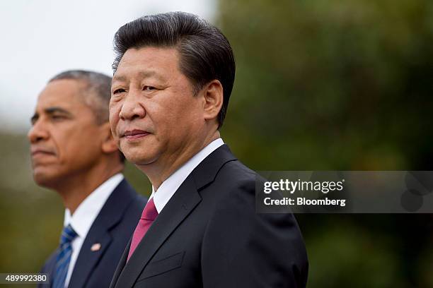 Xi Jinping, China's president, right, and U.S. President Barack Obama stand together during a state visit arrival ceremony on the South Lawn of the...