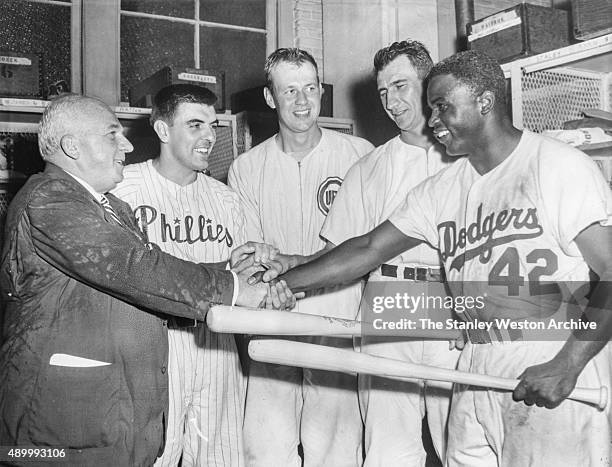 National League President Warren Giles congratulates Curt Simmons of the Philadelphia Phillies, Bob Rush and Hank Sauer of the Chicago Cubs and...