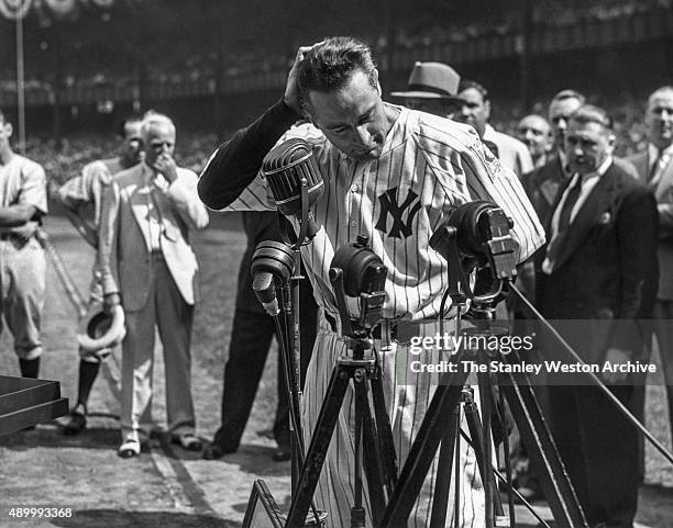 Lou Gehrig of the New York Yankees is shown before the mic delivering his farewell speech on Lou Gehrig Day on July 4, 1939 at Yankee Stadium in the...