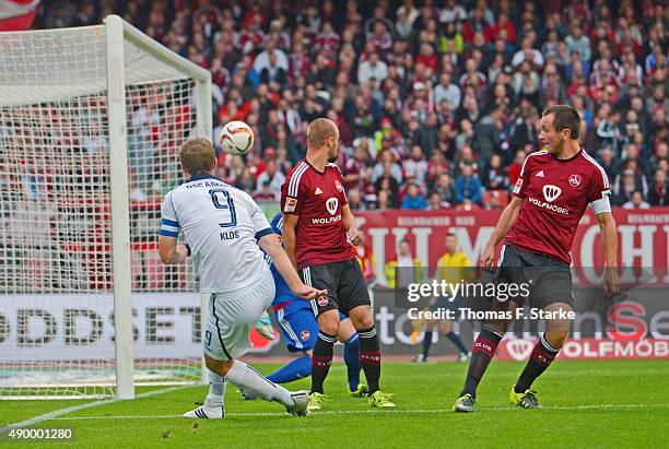 Fabian Klos of Bielefeld scores against Thorsten Kirschbaum , Miso Brecko and Even Hovland of Nuernberg during the Second Bundesliga match between 1....