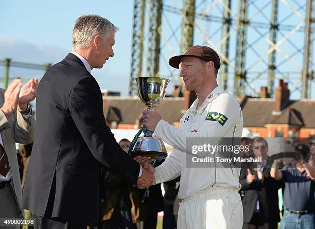 Gareth Batty of Surrey receives the trophy after winning of the Division 2 LV County Championship during the LV County Championship - Division Two...