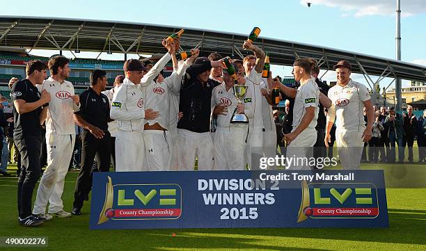 The players of Surrey celebrate winning the Division 2 LV County Championship during the LV County Championship - Division Two match between Surrey...