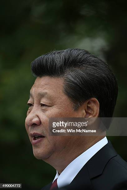 Chinese President Xi Jinping answers a question during a joint press conference with U.S. President Barack Obama in the Rose Garden at The White...
