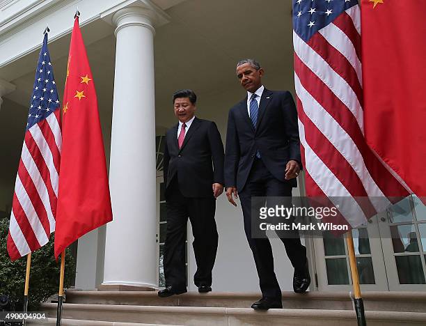 President Barack Obama and Chinese President Xi Jinping walk arrive to a joint news conference in the Rose Garden at The White House on September 25,...