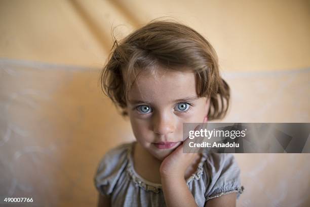 Sehat Fetih, a Syrian refugee girl who fled Homs with her family, is seen in her family's tent at a tent city in the Akcakale District of Sanliurfa,...