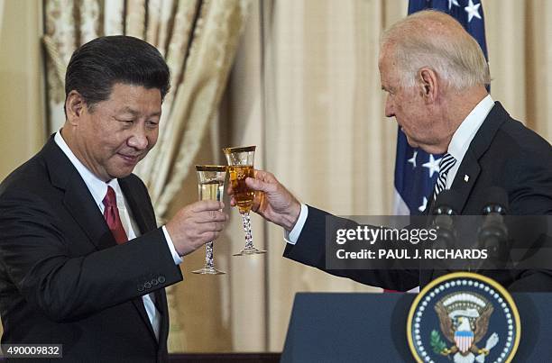 Vice President Joe Biden and Chinese President Xi Jinping toast during a State Luncheon for China hosted by US Secretary of State John Kerry on...