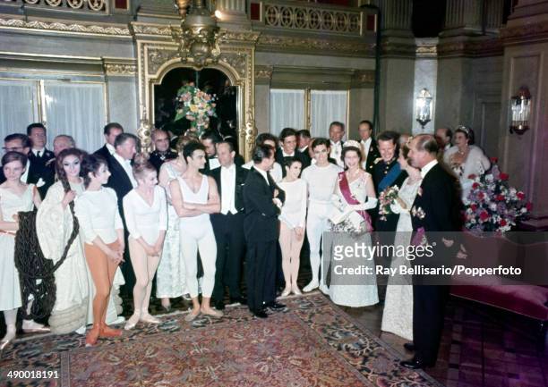 Queen Elizabeth II , King Baudouin, Queen Fabiola and Prince Philip with the cast at the Monnaie Theatre in Brussels after a ballet performance on...