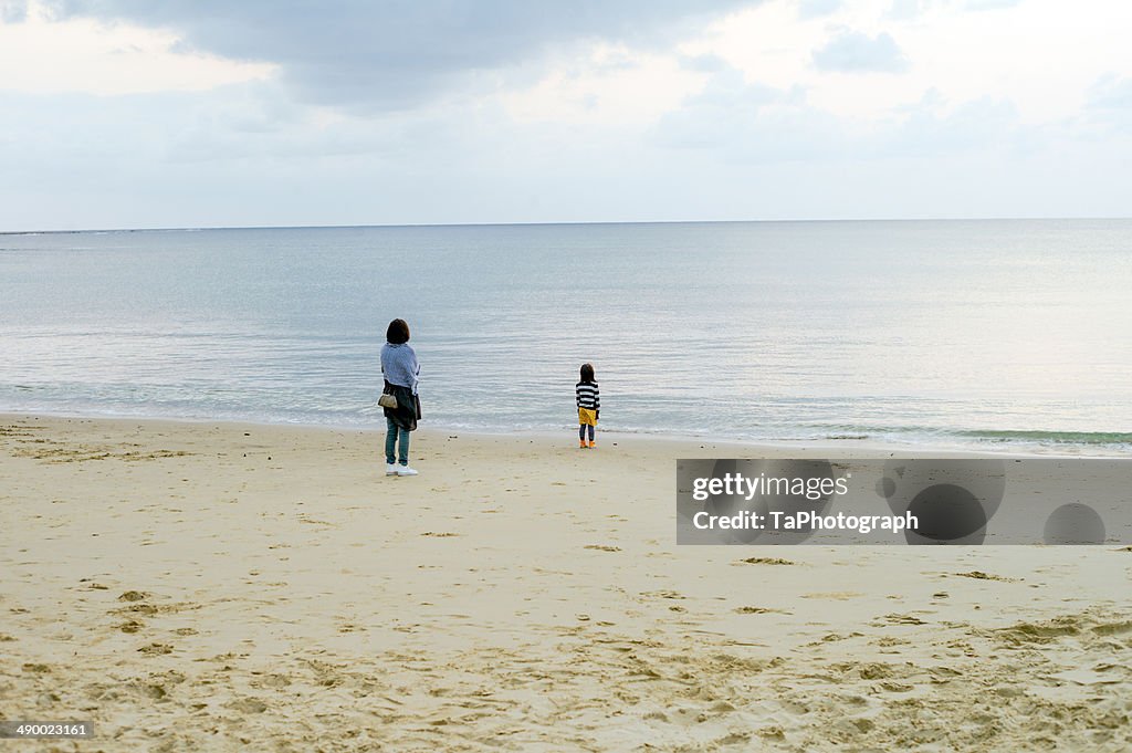 Mother and daughter looking at the sea