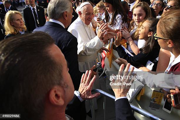 Pope Francis greets guests upon his arrival at Our Lady Queen of Angels School on September 25, 2015 in the East Harlem neighborhood of New York...