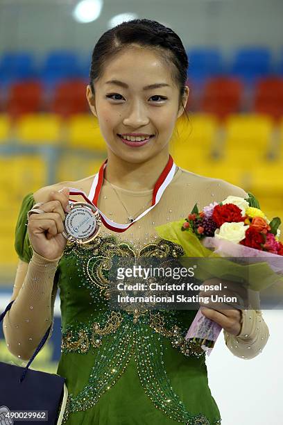 Rin Nitaya of Japan presents the bronze medal during the medal ceremony of the junior ladies competition of the ISU Junior Grand Prix at Tor-Tor...