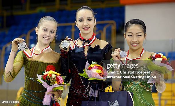 Ekaterina Mitrofanova of Russia presents the silver medal, Polina Tsurskaya of Russia presents the gold medal and Rin Nitaya of Japan presents the...