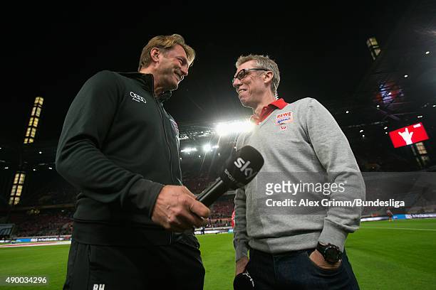 Head coaches Ralph Hasenhuettl of Ingolstadt and Peter Stoeger of Koeln chat prior to the Bundesliga match between 1. FC Koeln and FC Ingolstadt at...