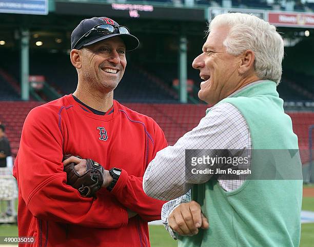 Frank Wren, who has been hired as the Boston Red Sox's vice president of baseball operations, speaks with interim manager Torey Lovullo before a game...