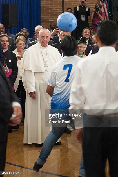 Pope Francis watches a soccer demonstration inside Our Lady Queen of Angels School September 25, 2015 in the East Harlem neighborhood of New York...