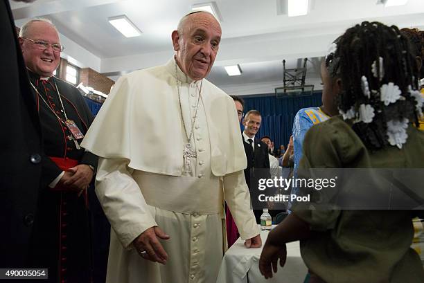 Pope Francis greets people inside Our Lady Queen of Angels School September 25, 2015 in the East Harlem neighborhood of New York City. Pope Francis...