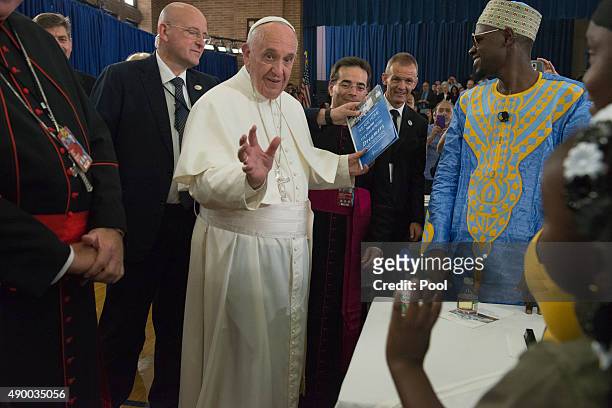 Pope Francis greets people inside Our Lady Queen of Angels School September 25, 2015 in the East Harlem neighborhood of New York City. Pope Francis...