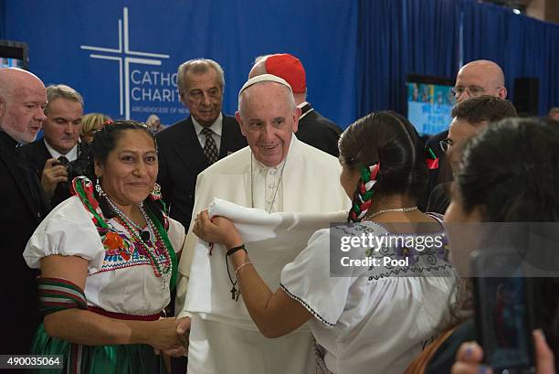 Pope Francis receives a gift inside Our Lady Queen of Angels School September 25, 2015 in the East Harlem neighborhood of New York City. Pope Francis...
