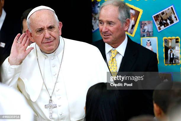 Pope Francis listens to children singing during a visit to Our Lady Queen of Angels School September 21, 2015 in the East Harlem neighborhood of New...