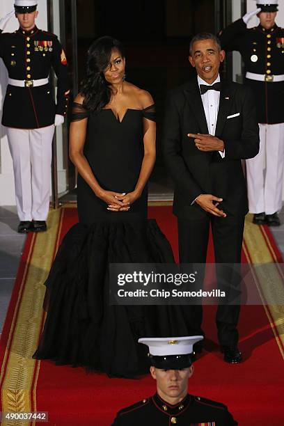 First Lady Michelle Obama and U.S. President Barack Obama wait on the North Portico for the arrival of Chinese President Xi Jinping and his wife...