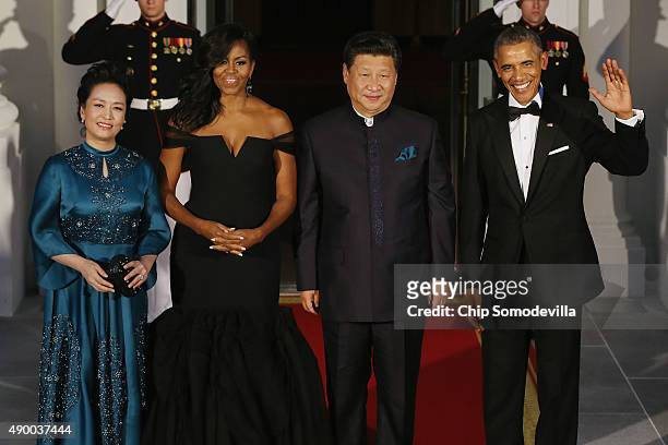 Madame Peng Liyuan, U.S. First Lady Michelle Obama, Chinese President Xi Jinping and U.S. President Barack Obama pose for photographers on the North...