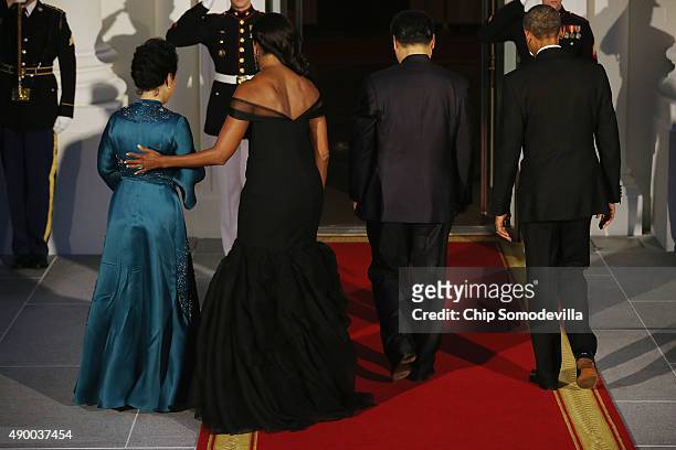 Madame Peng Liyuan, U.S. First Lady Michelle Obama, Chinese President Xi Jinping and U.S. President Barack Obama walk inside the White House for a...