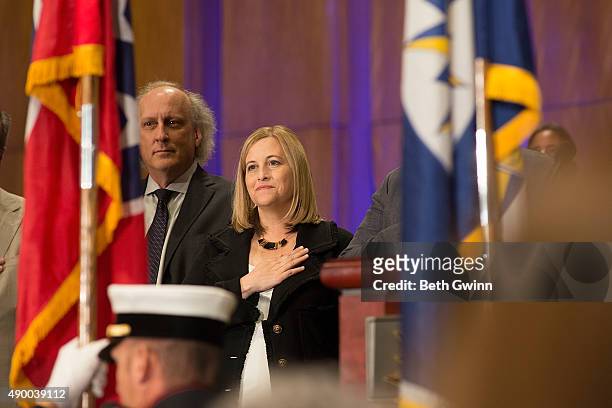 Bruce Barry and Megan Barry salute the flag at Music City Center on September 25, 2015 in Nashville, Tennessee.