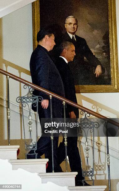 President Barack Obama and President Xi Jinping of China descend the Grand Staircase to pose for a formal photo prior to a state dinner at the White...