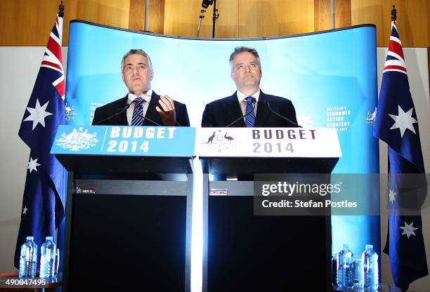 Treasurer Joe Hockey and Finance Minister Mathias Cormann speak to the media during a press conference within the budget lockup at Parliament House...