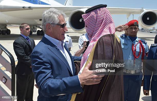 Defense Secretary Chuck Hagel is welcomed by Saudi Deputy Defense Minister Salman bin Sultan upon his arrival at King Abdulaziz International Airport...